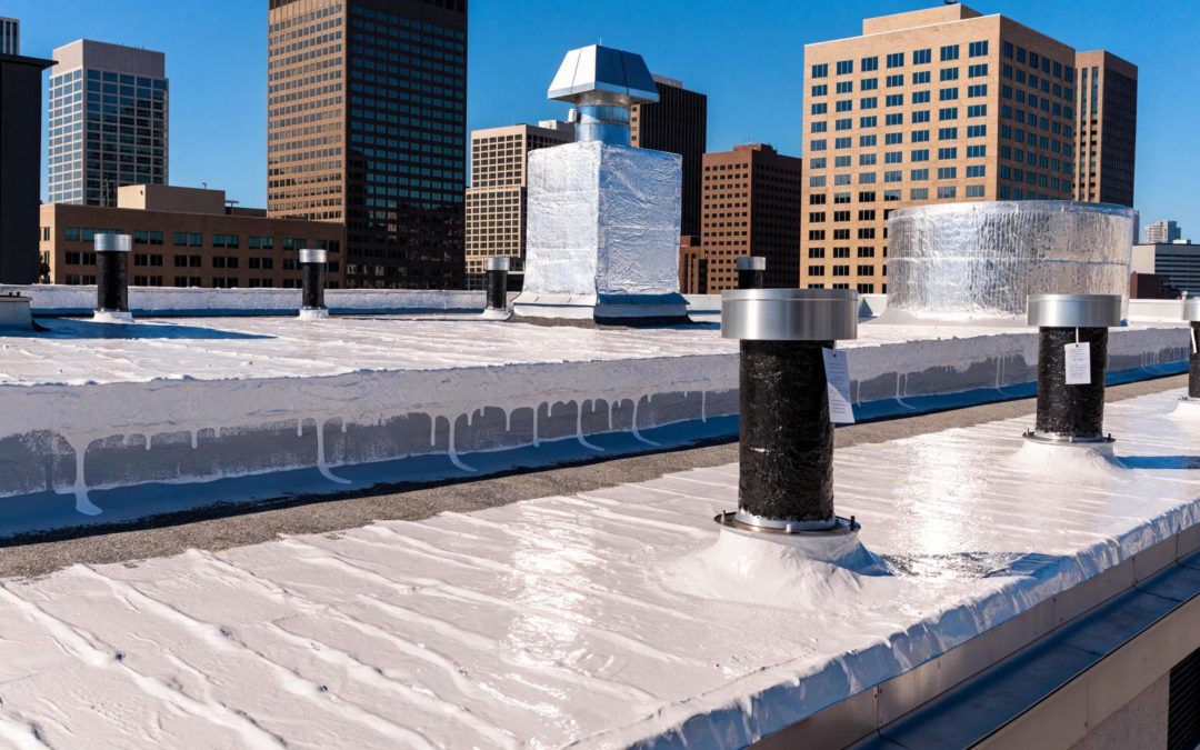 Commercial roof restoration with white coating and sealant around pipes in Houston.